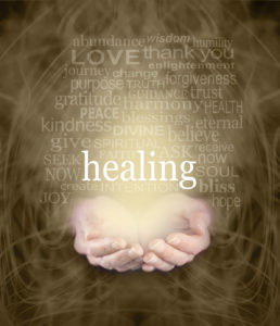 doc martin healing hour photo of open hands holding light with the word healing displayed prominently