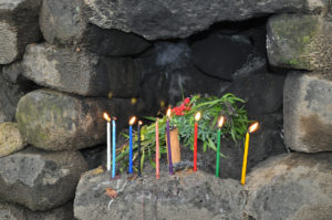 altar energy healing stones - photo of candles lit in a stone altar